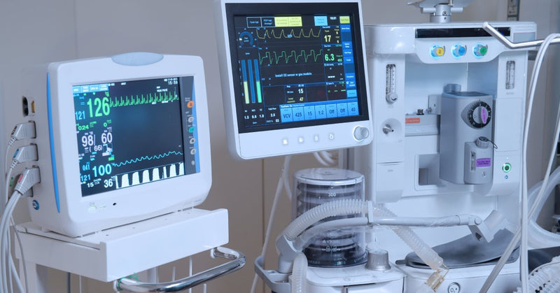 Multiple medical devices display patient diagnostics in a clean, modern medical office or hospital setting.