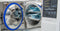 An autoclave sits on a white table. The door is open to reveal medical instruments in blue sterilization pouches.