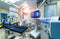  A high-tech operating room is filled with medical equipment like an X-ray scan, surgical table, and EKG machine.