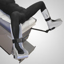 G Stirrups leg positioning device with adjustable straps, designed to secure a patient's legs during medical procedures, mounted on an examination table
